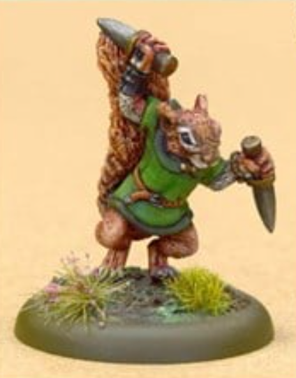 We have a 28mm model of an anthropomorphic squirrel. He's facing toward the camera and slightly to the right. He's wearing a green tunic. He has two daggers which he's holding up ready to attack. And behind him is his big ginger tail.