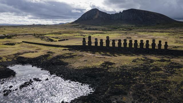 Moai statues stand on Ahu Tongariki near the Rano Raraku volcano, top, on Rapa Nui, or Easter Island, Chile, Nov. 27, 2022. (AP Photo/Esteban Felix, File)