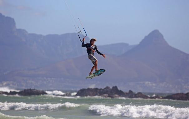 In this Sunday, February 2, 2014, file photo, a kite surfer surfs against the backdrop of Table Mountain in Cape Town, South Africa (AP)