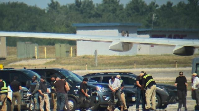 In this photo obtained by the Associated Press, ICE detainees line up to board a flight at Portsmouth International Airport at Pease, N.H., on Saturday, Aug. 16, 2025. (AP Photo)