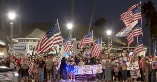 Hundreds gathered at the Huntington Beach Pier Saturday evening, Sept. 13, 2025, to honor polarizing conservative podcast host Charlie Kirk, who was fatally shot during a Turning Point USA event at Utah Valley University on Sept. 10.