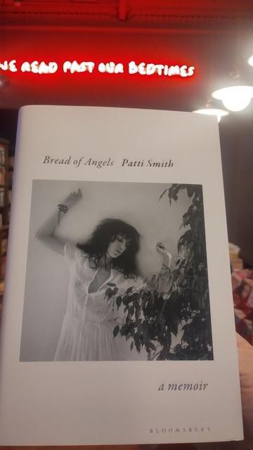 Black and White photo of Patti Smith in a white dress, on the cover of her Bread and Angels memoir Black and White photo of Patti Smith in a white dress, on the cover of her Bread and Angels memoir