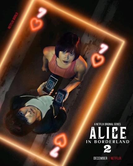 Alice in Borderland drama poster featuring a Seven of Hearts card with orange neon lit borders. Within these borders are Yamazaki Kento and Tsuchiya Tao looking upwards holding their cellphones.