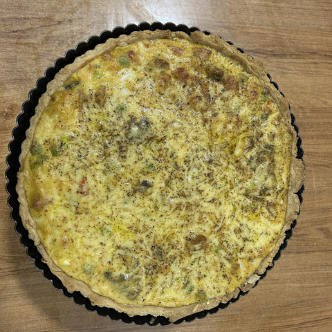 A pumpkin pie, fresh from the oven; with mushrooms, peas and cheese, and a roux-type sauce.