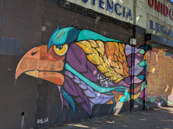 Street mural. Multicolored vivid eagle. Aztec influences?