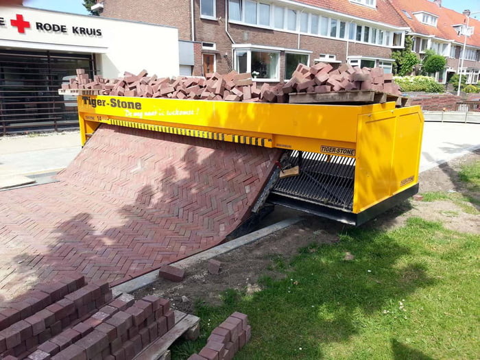 Put in the bricks on top and the machine will sort and put them into shape rolling out a new brick road 

Easy peasy 
