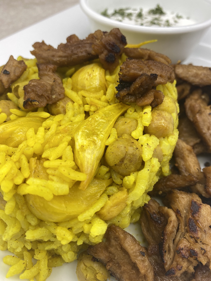 Close up showing large cloves of garlic in the rice