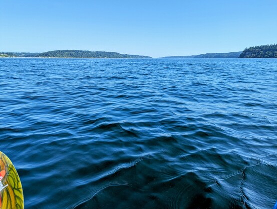 Small waves or wake in the vivid blue waters of the Puget Sound near Tacoma, Washington.
