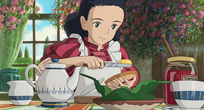 Himi, holding a knife and spreading butter to her bread.