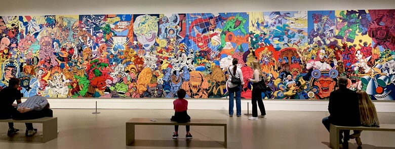 The collage repainted on a large scale, taking up the wall of a gallery.