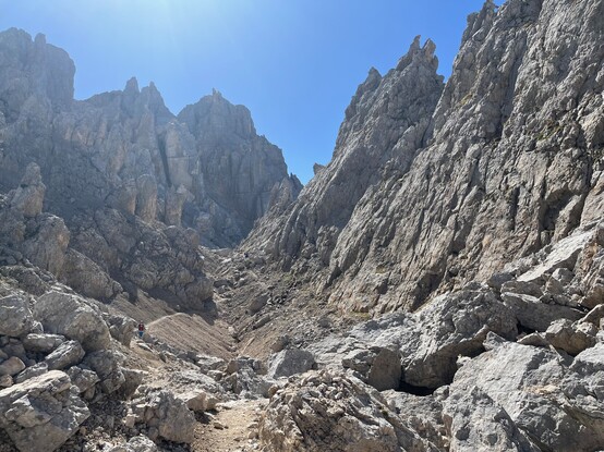One more rocky valley with a path winding between jagged peaks and walls. Hiker provided for scale :^).