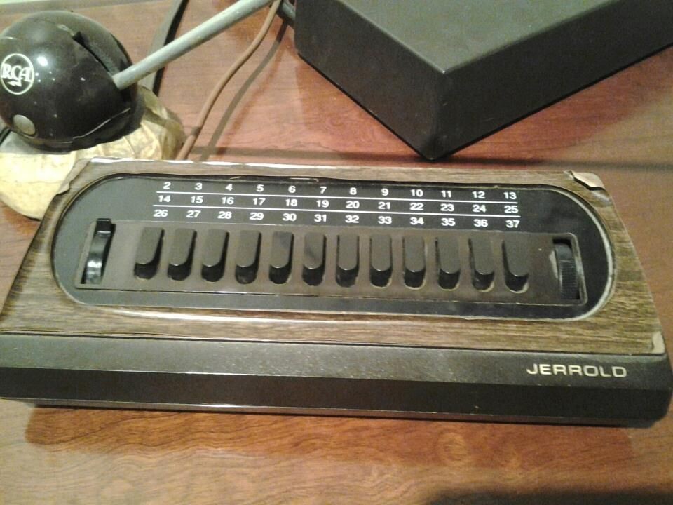 a rectangular faux wood box with 12 buttons on it and 3-level selector switch so user can select 1 of 36 channels. a tuning dial on the right? (i forget)