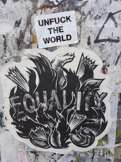 Street art capturing-- #Equality wood block cut paper print with Unfuck the World sticker above it on the Street. Photo by Shell Sheddy #streetArt #shellsheddy #sheShePhotography #sheshephoto #unfucktheworld #DoSomething #doWhatYouCan #youAreImportant We must #SaveOurDemocracy together