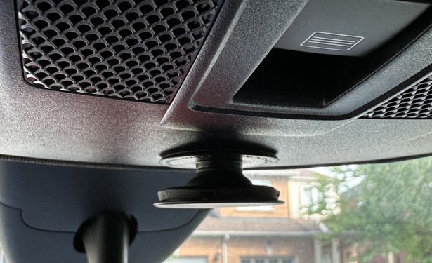 Pop socket installed in a car to be used as a holder for sunglasses