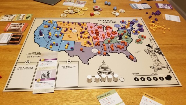 The Votes for Women game board shows a map of the US split into 7 differently colored regions. My Opposition tokens are concentrated in the Midwest and South. The Suffragist tokens have their stronghold out west. It's the beginning of the last turn and the Suffragists still need one more Congressional marker before they can even send the amendment to the states. If they fail, the Opposition immediately wins, so that's what I'm hoping for!