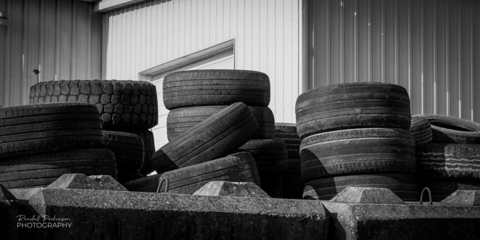 Stacks of Old Tires being large concrete retaining wall blocks. 