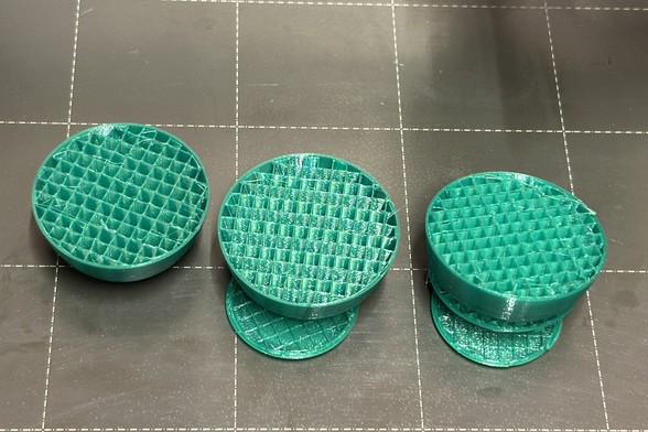 A failed 3D print of 3 green dwarf bodies. Two of them are split in the middle due to under extrusion caused by partially clogged nozzle which was caused by wet filament 