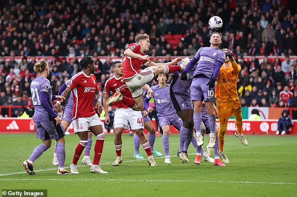 Alexis Mac Allister, in purple, heads the ball away. Just behind him, Nottingham Forest's captain, Ryan Yates, is flying in with his leg well above-the shoulders of the standing players. He collides with Konate who is trying to shield himself from the impact.