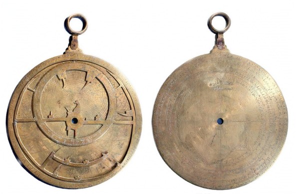 A brass astrolabe seen from the front and back.