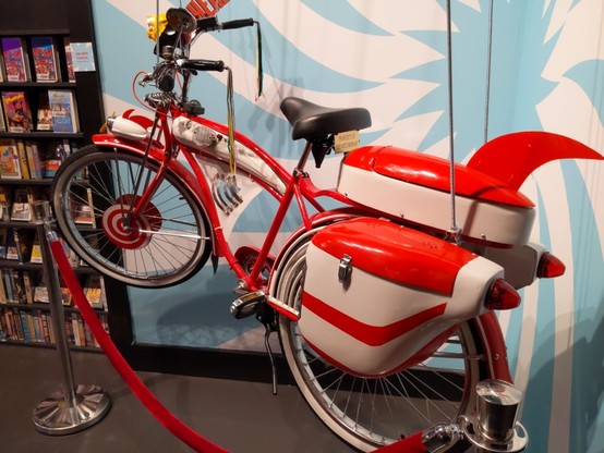 A red and white bicycle with which I assume to be Pee Wee Herman's bike.