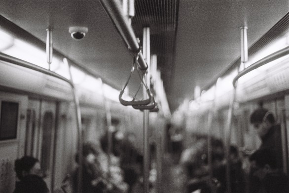A black and white picture of the inside of a metro train.