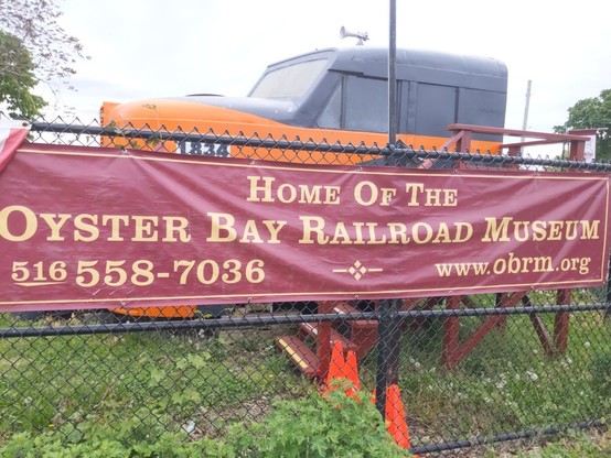 A sign giving phone number and url of the Oyster Bay Railroad Museum.
516 558-7036 www.obrm.org