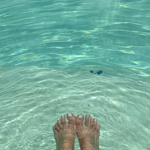 iPhone photo of my ridiculous monkey toes with pale pink nail polish in the cool, sparkly, turquoise pool 