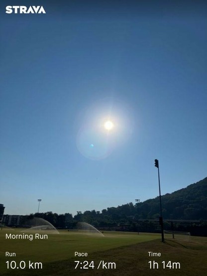 An angry, spiteful sun wrathfully glares over the valley, fully intent on sharing a malicious heat upon the poor inhabitants below. My running stats are along the bottom: 10.0 km distance, 7:24 per km pace, and total time of 1 hour 14 minutes.