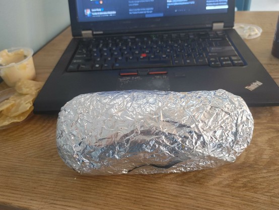 Burrito, significant portion of the width of my laptop. Wrapped and snuggly. 