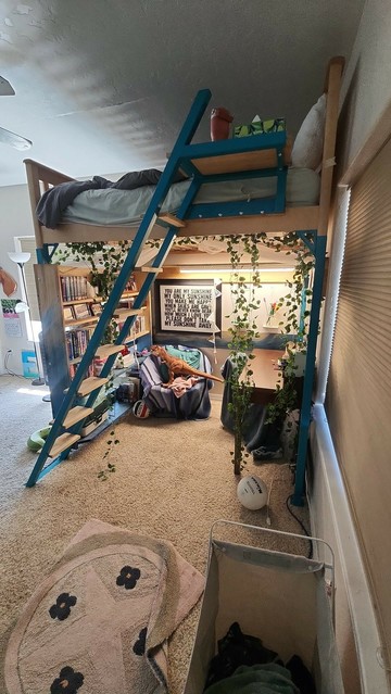 Picture of a kids room from reddit with a loft bed and a reading area underneath with a desk. 