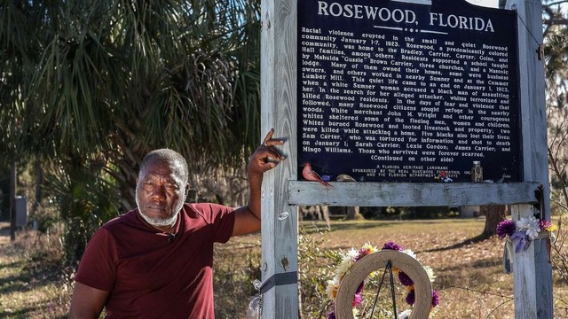 Retired FIU professor Marvin Dunn, seen on Feb. 8, 2021, leans on a sign erected by the state of Florida in 2004 along Highway 24 in memory of Rosewood, a majority-Black hamlet west of Gainesville burned to the ground in 1923 after a white woman claimed she’d been attacked in her home by a Black man. Carl Juste cjuste@miamiherald.com

Read more at: https://www.miamiherald.com/news/local/community/miami-dade/community-voices/article289744509.html#storylink=cpy