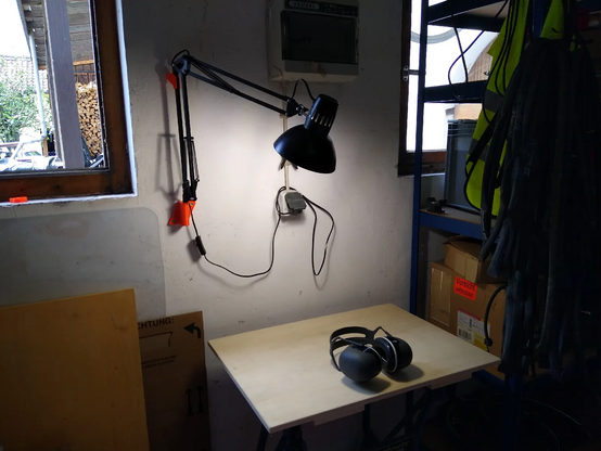 a desktop lamp mounted to the wall in my garage; I can move the lamp to put the light wherever I need without blocking any space of the tine workbench; very useful when working on my bikes (which are not in the picture)