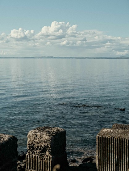 A colour photo of a very calm and sunny Firth Of Forth, looking from Longniddry Bents over the tank traps across to Fife. Scotland.

Photo by and copyright of Paul Henni.