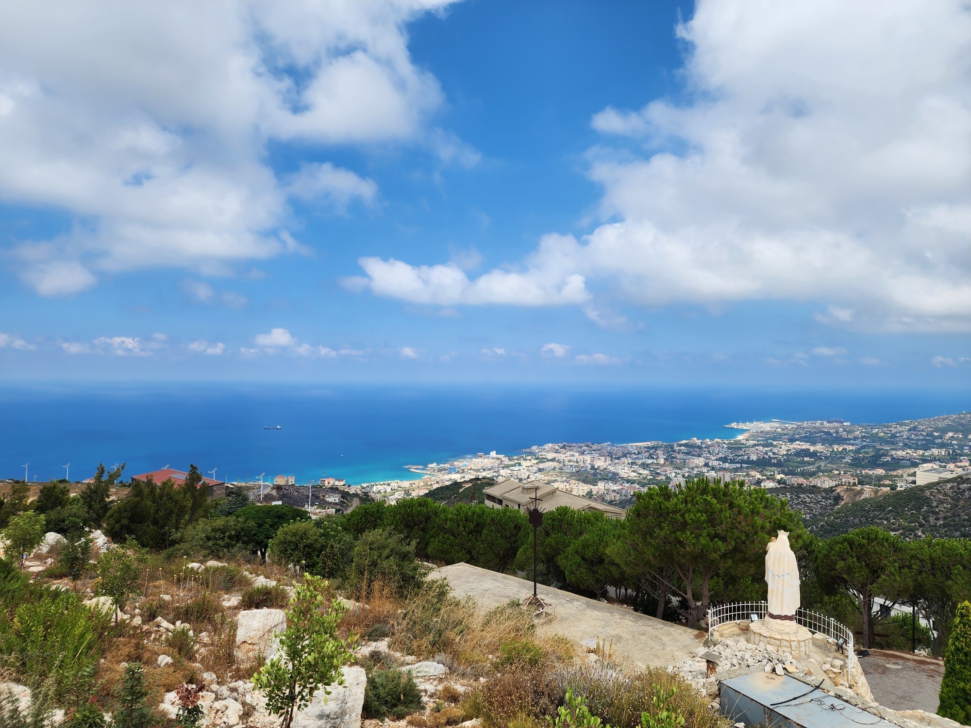 View from the top of a hill onto the town of Batroun and the Mediterranean Sea.