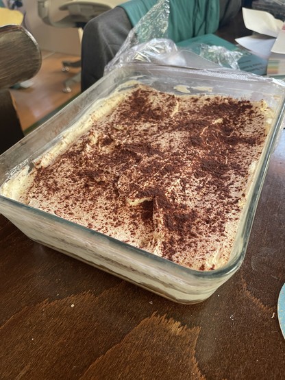 A delicious-looking tiramisu occupying a whole glass dish
