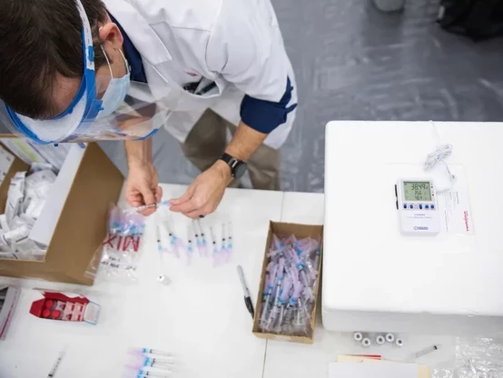A technician prepares COVID vaccine injections.  Getty Images.