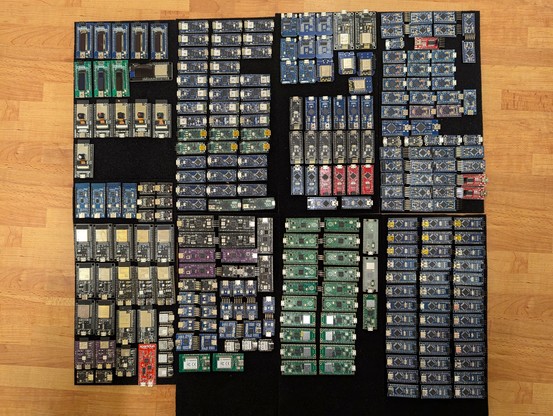 Photo of around 274 small printed circuit boards, mostly original and legal clone Arduinos, with other families of board, some breadboard-friendly and many not