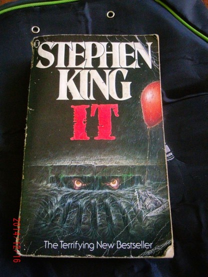 Beat up paperback book. Stephen King. IT. The Terrifying New Bestseller.
