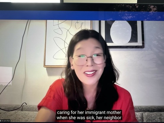 Ai-Jen Poo I. A red shirt and glasses, talking about how Kamala has lived many of our experiences as women. 