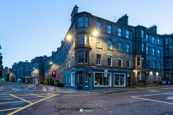 The corner of a street of Tenement buildings in Newington, Edinburgh. Shot pre dawn when street lights are still on but daylight is starting to make an appearance.