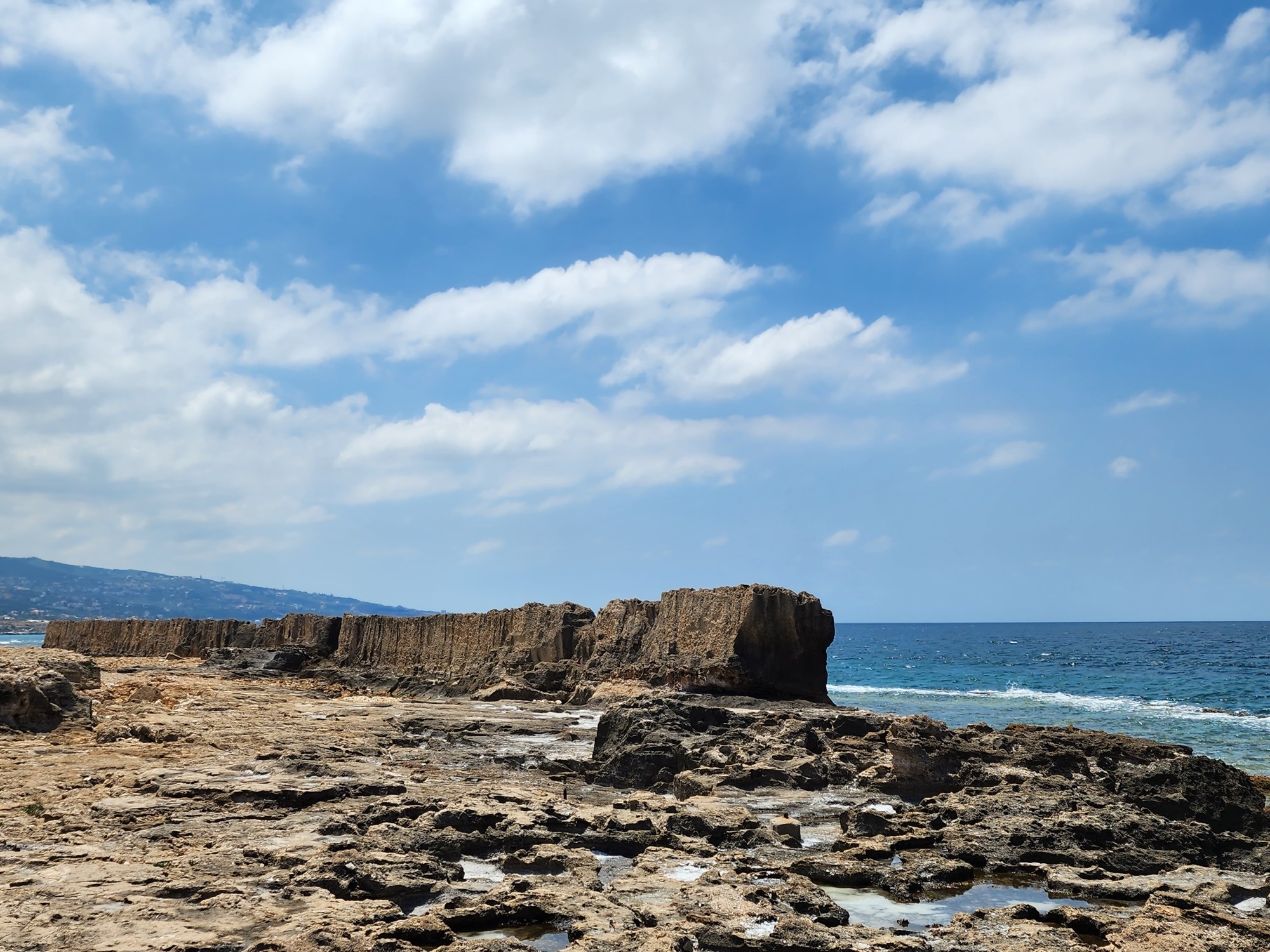 earthen wall about 10 ft high, 8 ft thick and 200 ft long on a rocky beach on the Mediterranean.