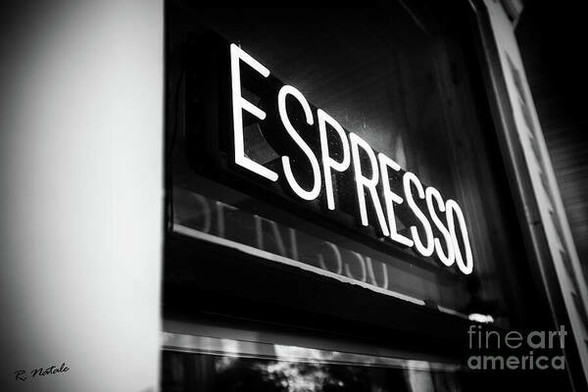 B&W photo of a neon sign at a cafe reading 