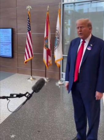 Trump answering some questions at the entrance of a voting station in Florida.