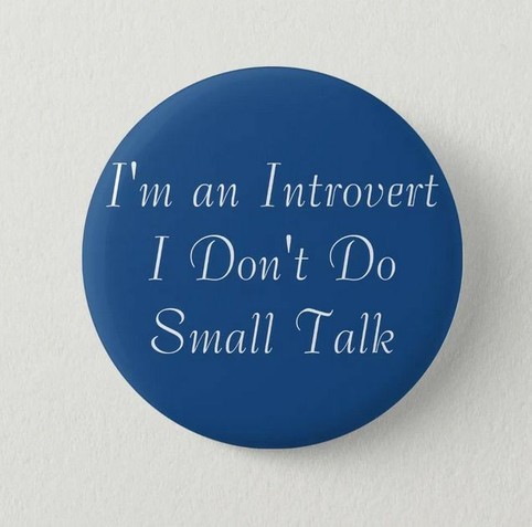 blue button pin with white writing that says 'I'm an Intovert. I don't do small talk.'