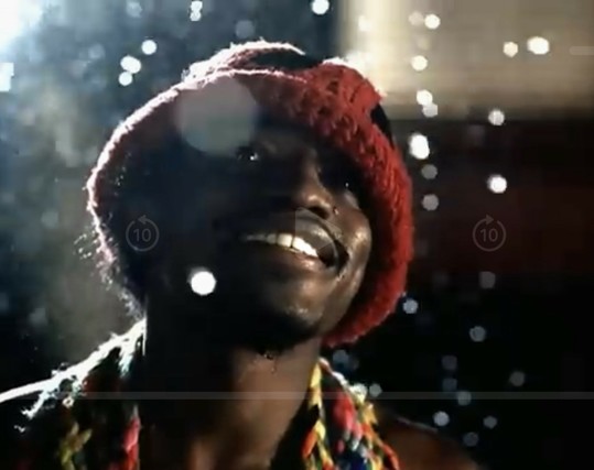 A man is standing in the rain. It’s a close up shot. He is wearing a red toboggan, is looking up and smiling. And Andre is sorry, Ms. Jackson. 