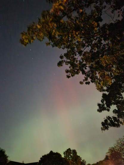 Aurora borealis with green streaks and red pillars