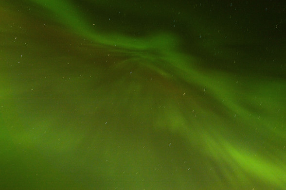 Blurry stars and a green aurora overhead on a windy night...