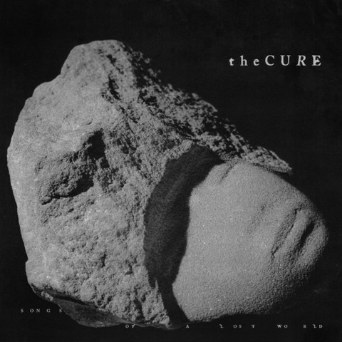 A large rock like a stray asteroid floats in a black void on the cover of The Cure's 2024 album Songs of a Lost World. 