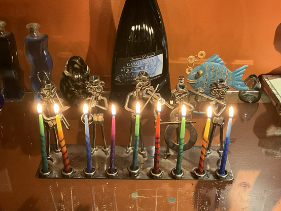 Hanukkah menorah with jazz musician figures there are nine candles filling all of the spots for the final night of Hanukkah