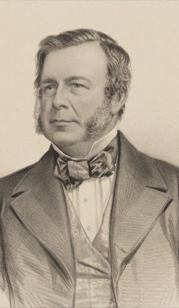 Portrait of Mechi. Suited with bow tie. Head and shoulders. Looking left. Full face with a decent pair of mutton chops. Full head of hair, side parting. In his late 50s?